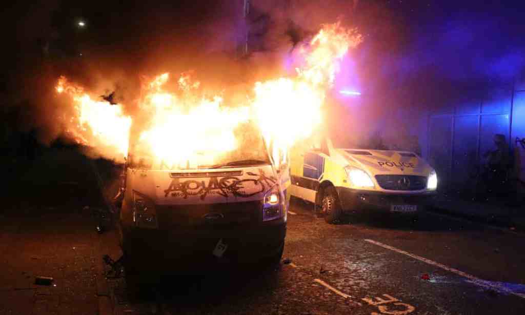 A vandalised police van on fire outside Bridewell police station in Bristol. Photograph: Andrew Matthews/PA